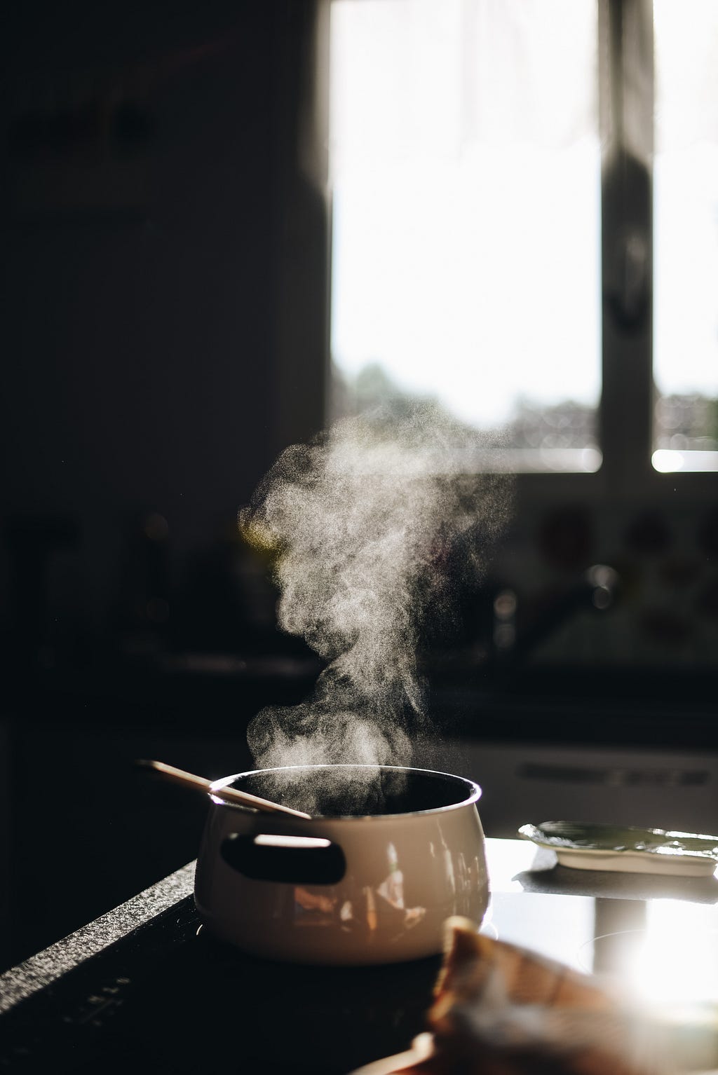 Image of a smoke emitting pan kept on stove