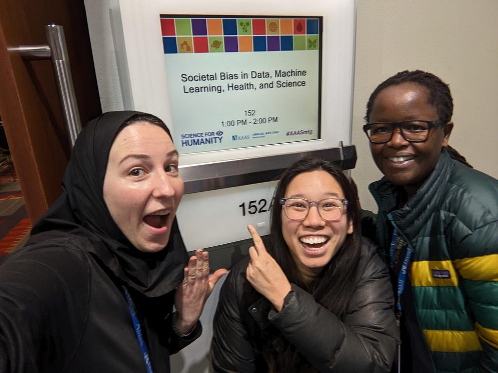 Marzyeh, Irene and Judy grouped together, pointing to the sign for our AAAS panel on Societal Bias in Data, Machine Learning, Health, and Science and smiling