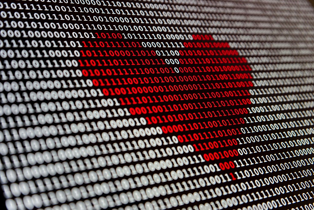 Red heart made out of computer binary