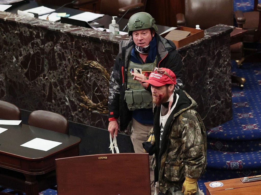 Retired Air Force officer Larry Rendall Brock, Jr., wearing a combat helmet, in the Senate chamber.