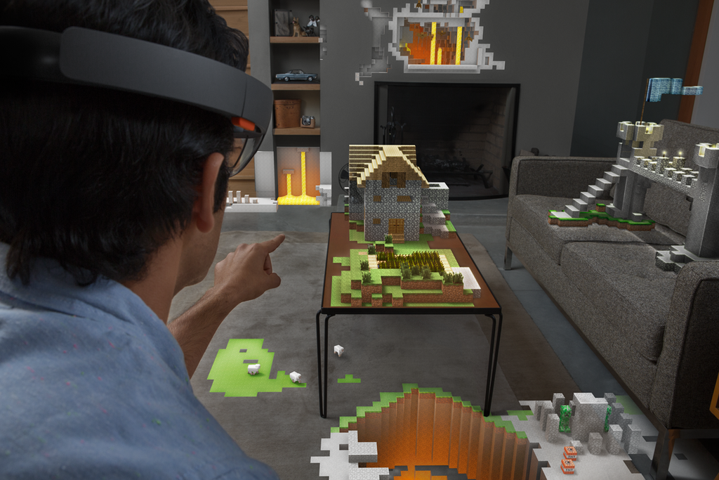 Minecraft running on top of a table top while the gamer is wearing a HoloLens to control and build objects in the virtual world. 