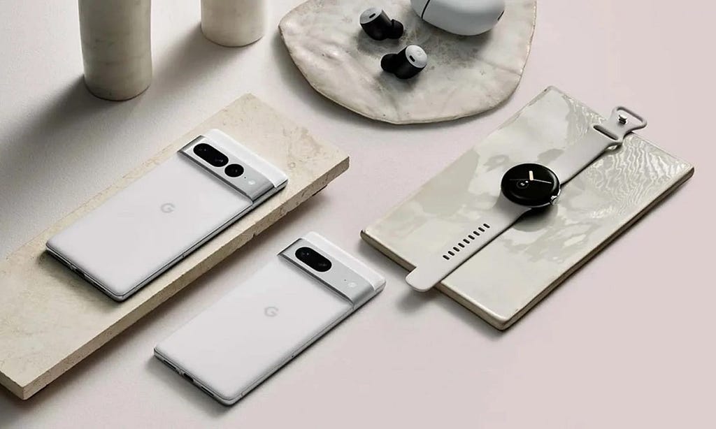 Made by Google products laid out on a table, including phone, watch and ear buds.