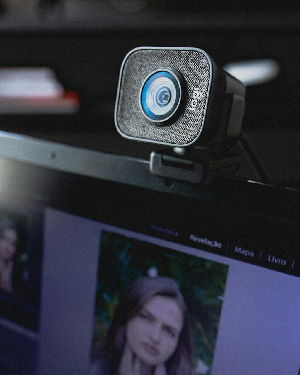 modern external video camera or webcam hanging on display of laptop
