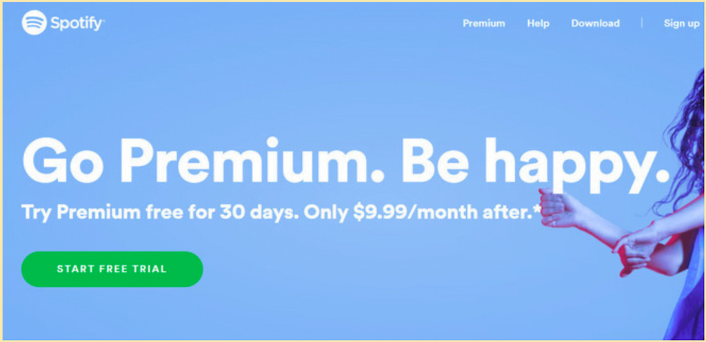 A Spotify banner screenshot with the title ‘Go Premium. Be happy’ and subtext ‘Try Premium free for 30 days. Only $9.99/month after”. Then a CTA saying ‘FREE TRIAL.’