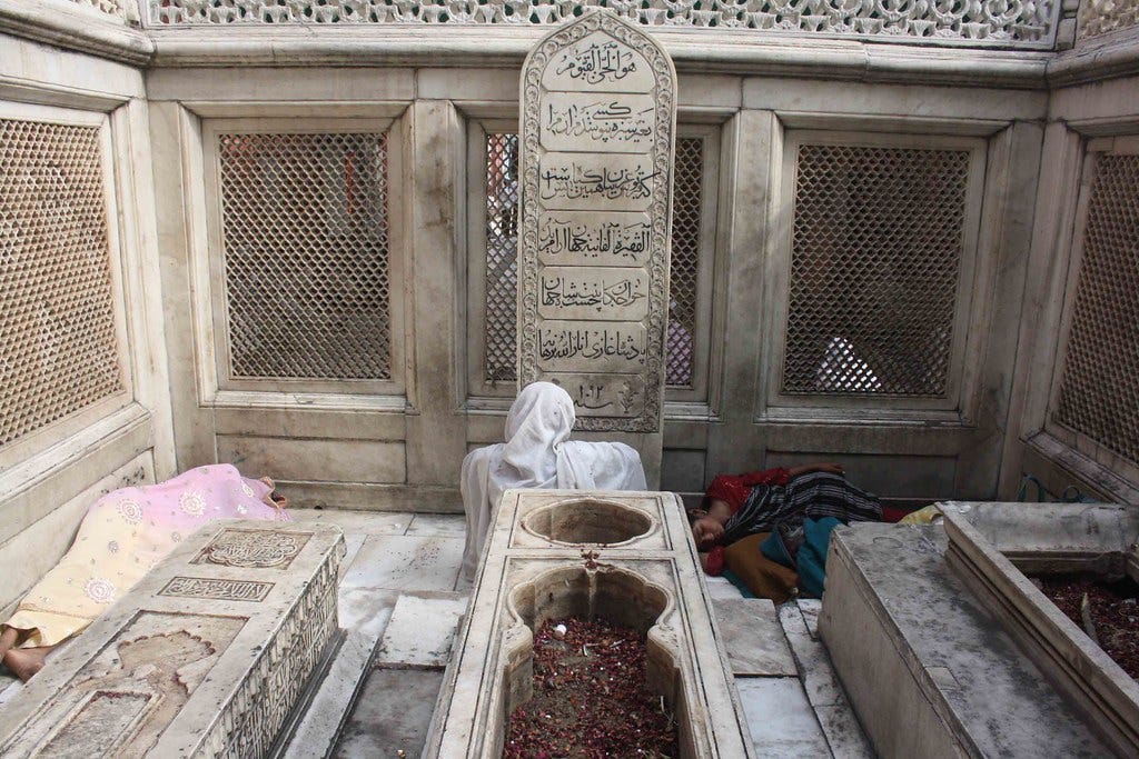 Women sitting near tomb