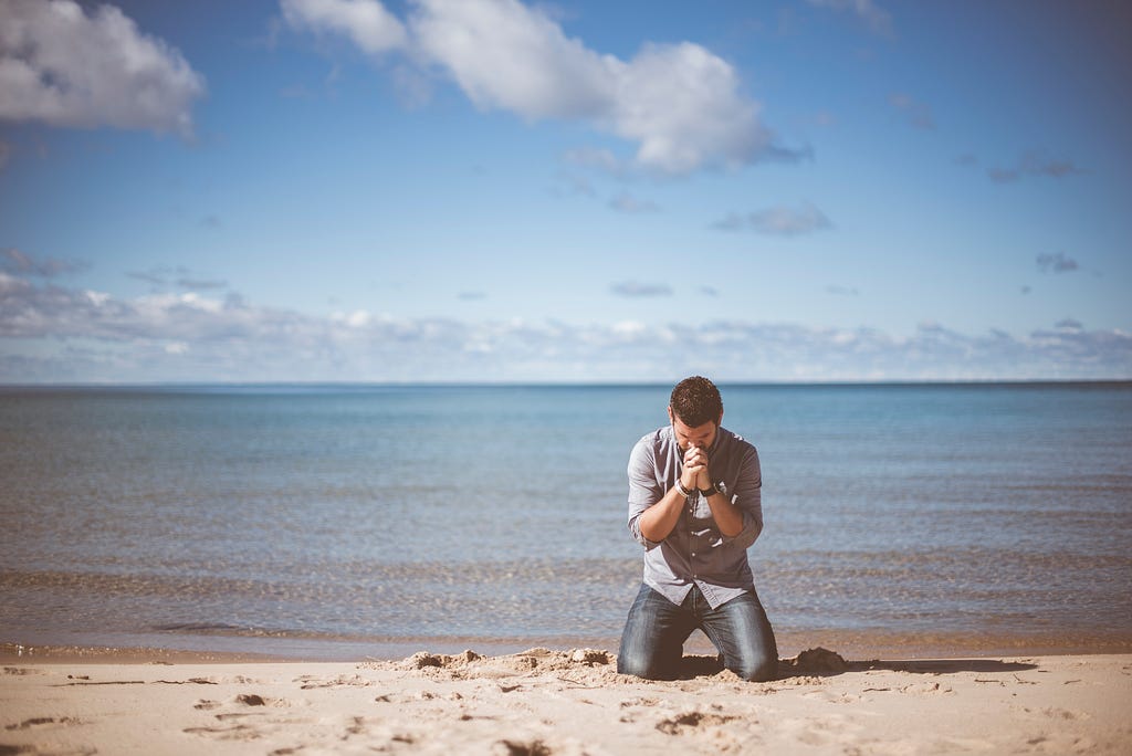 A man desperately praying