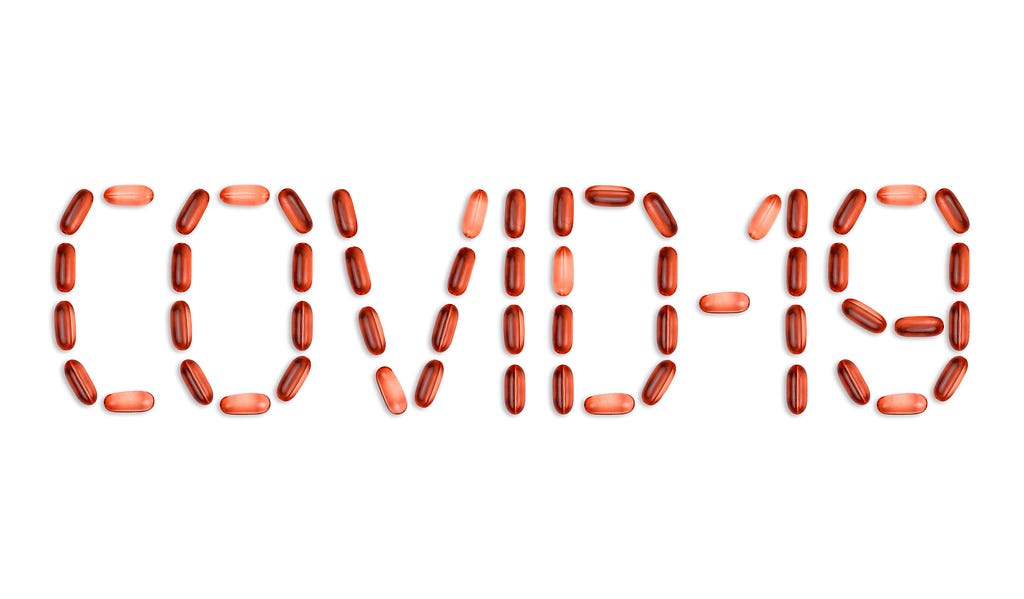 Capsules spelling out the name covid-19
