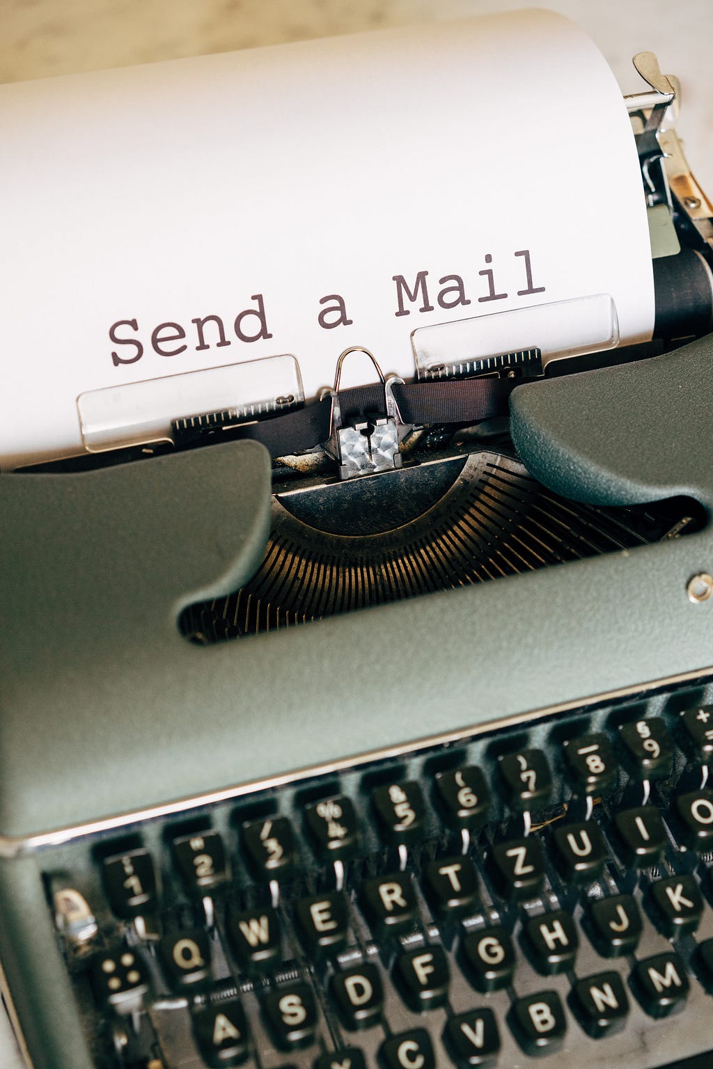 An antique typewriter that sits on a wooden table