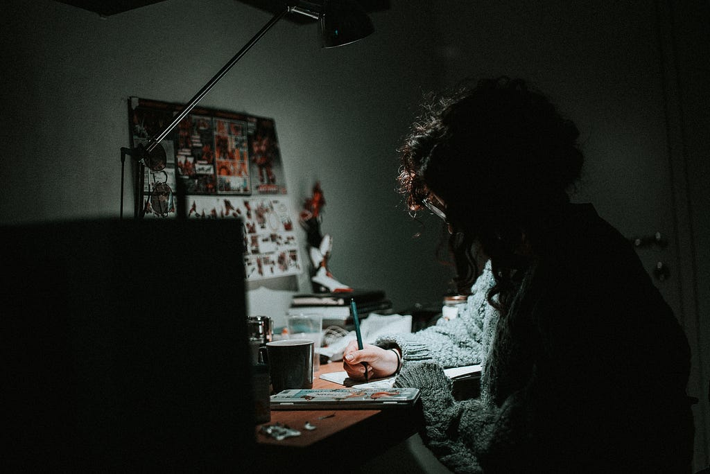 Girl working in a dark environment.