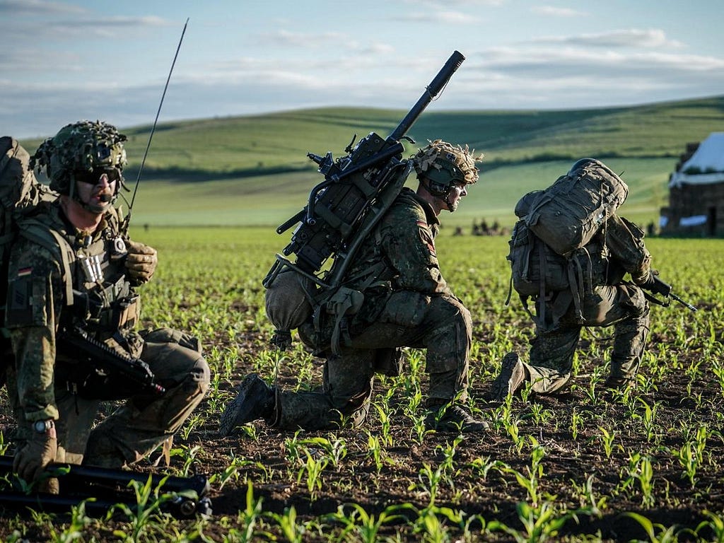 Bundeswehr paratroopers take up position after landing during NATO exercises at the 71st Airbase in Romania, May 13, 2024. Photo by Kay Nietfeld/dpa/Reuters