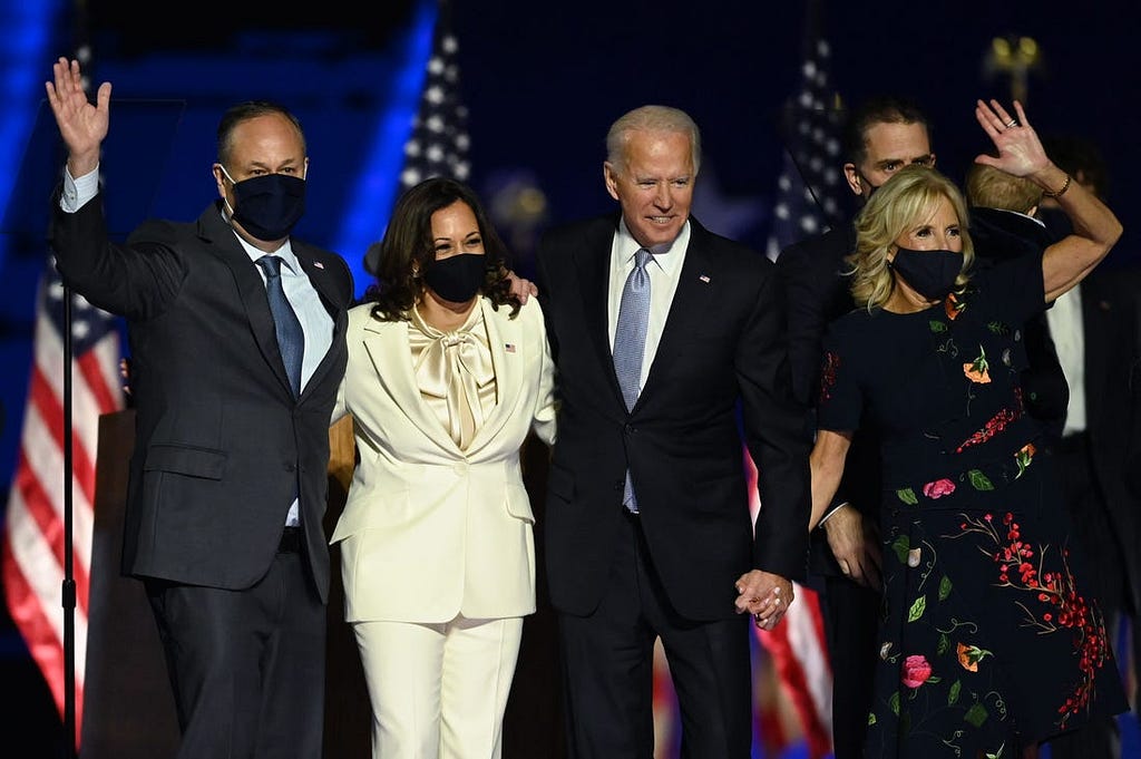 Joe Biden and Kamala Harris stand with their spouses, Jill Biden and Doug Emhoff.