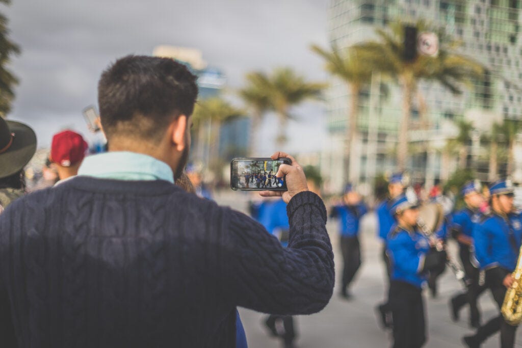 Man taking a picture of an Easter Parade — History of Easter