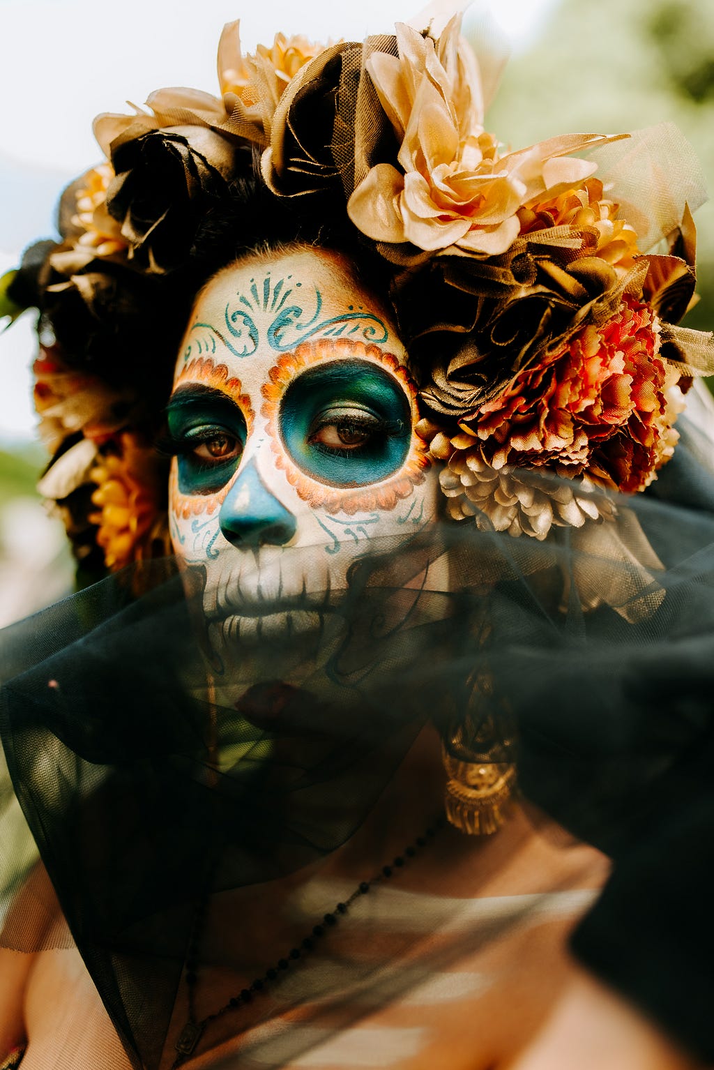 A women wearing a skull-ish make up, celebrating Dia De Los Muertos, the festival of the dead in Mexico