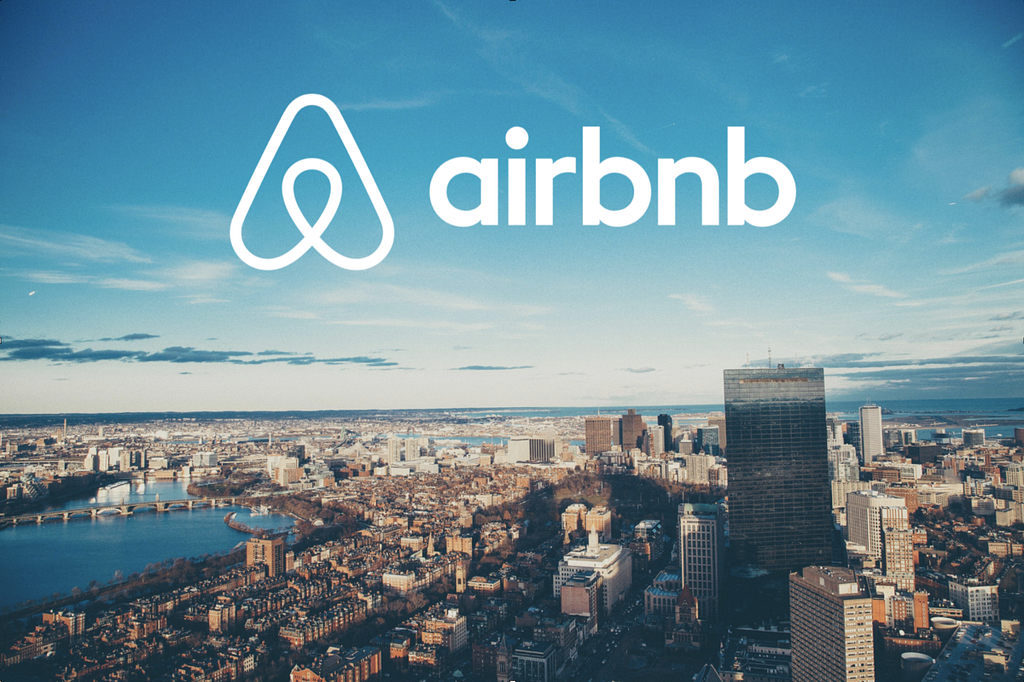 Airbnb logo over a city