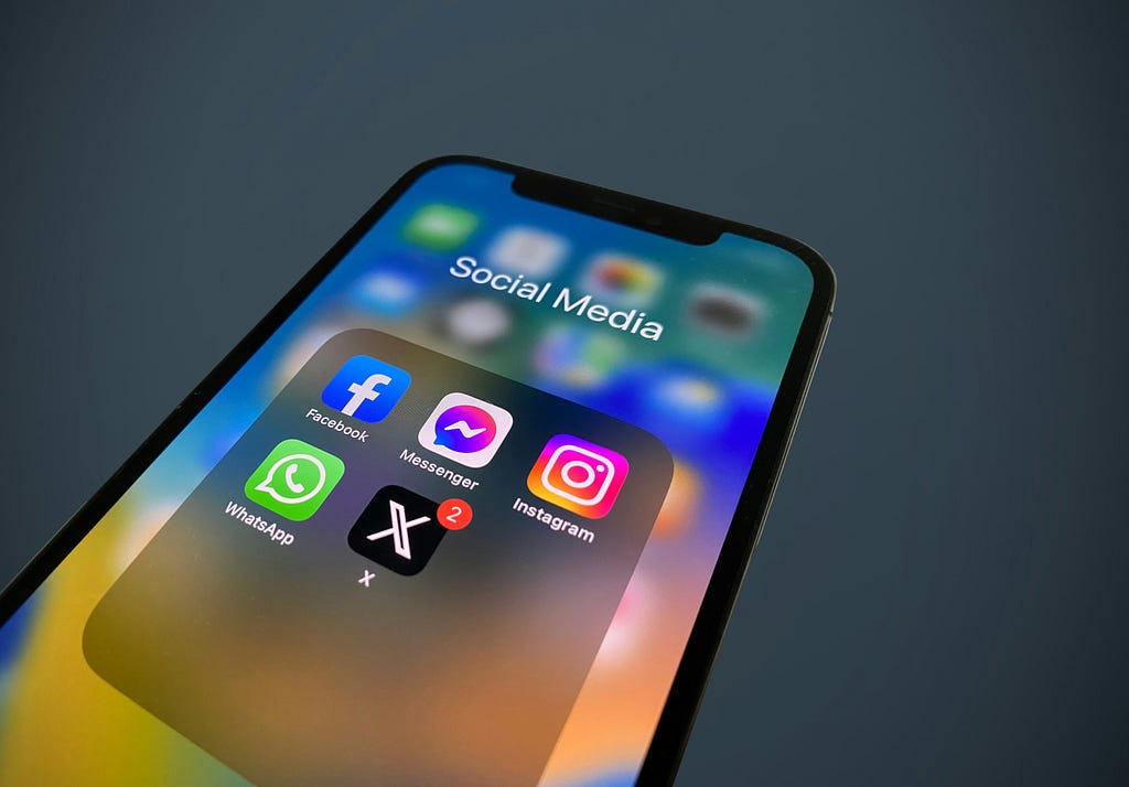 A phone showing social media app widgets including X
