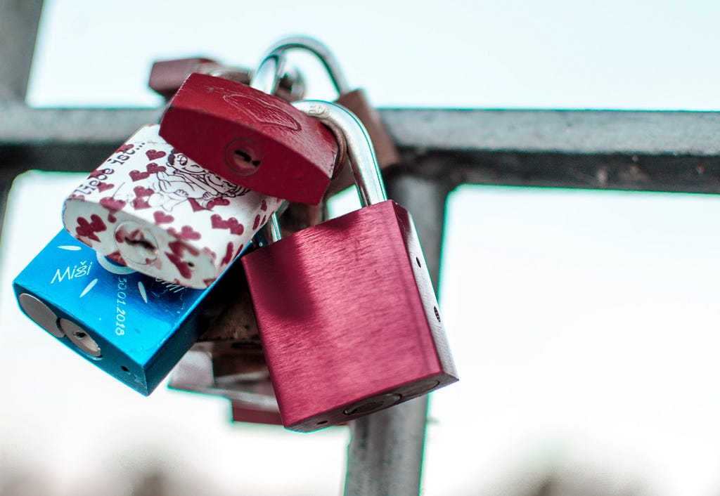 Picture of “love padlocks” on a fence.