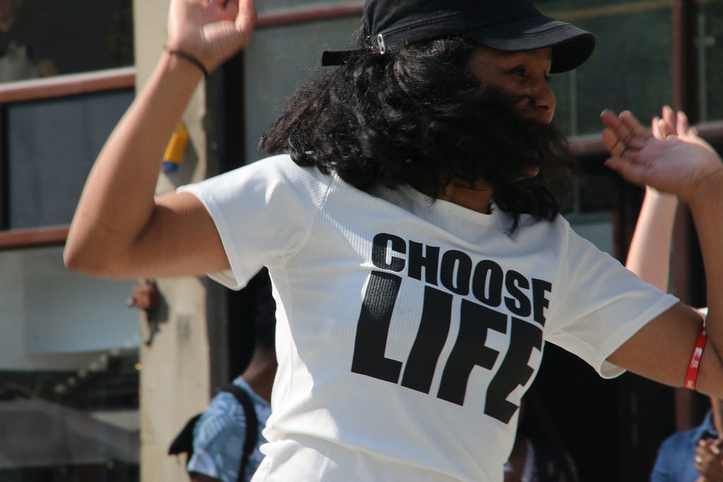 Girl wearing the “choose life” white t-shirt.