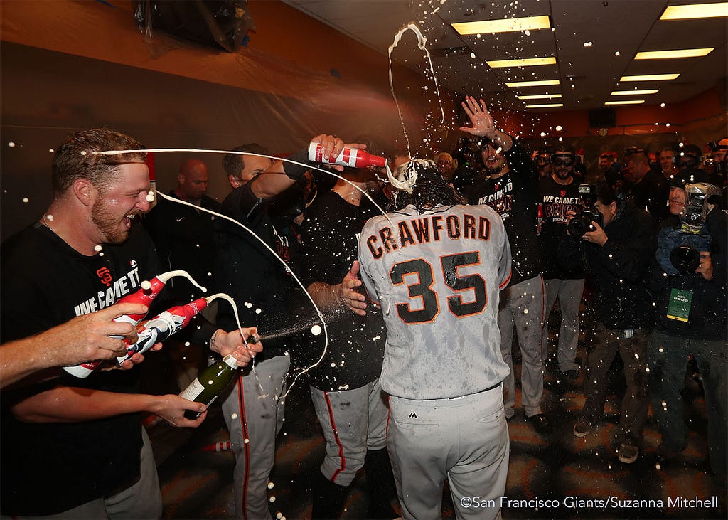 The team soaks Brandon Crawford in the clubhouse.