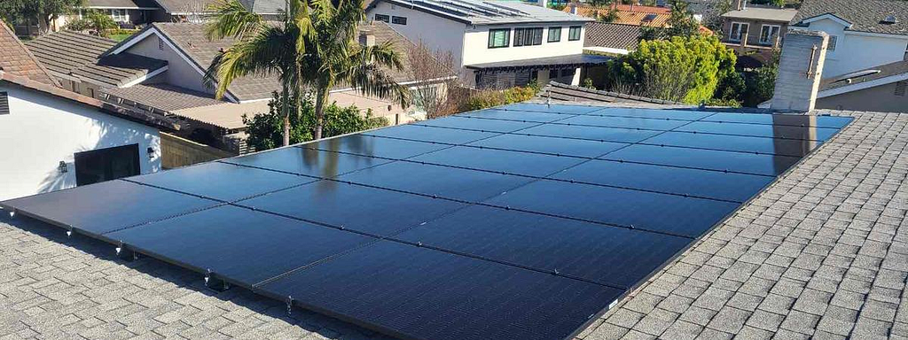 top view of house roof with black solar panels
