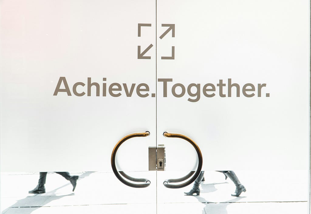 an image written ‘Achieve. Together.’