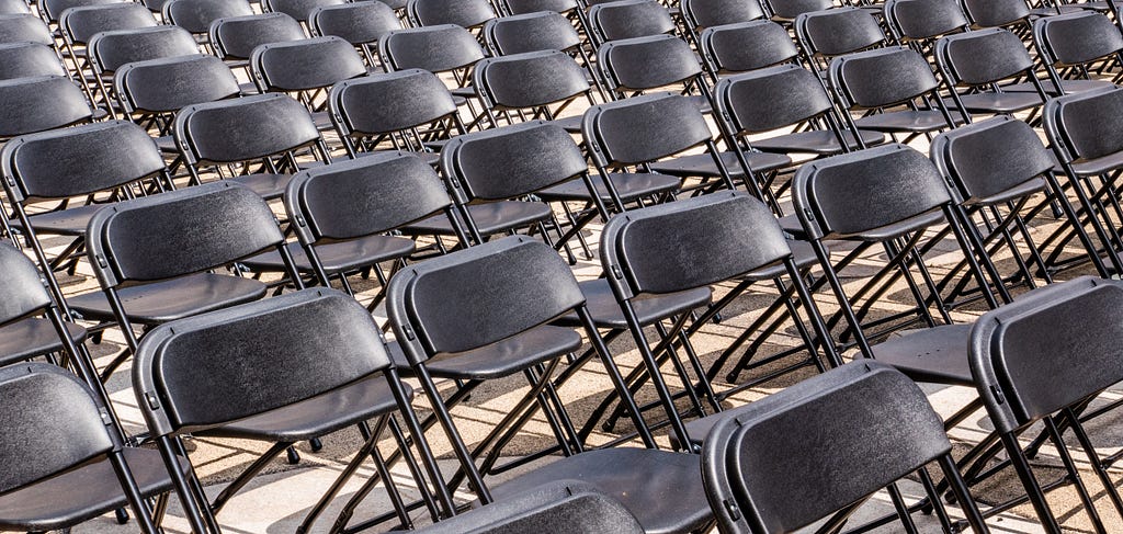 Image of rows of folding chairs.