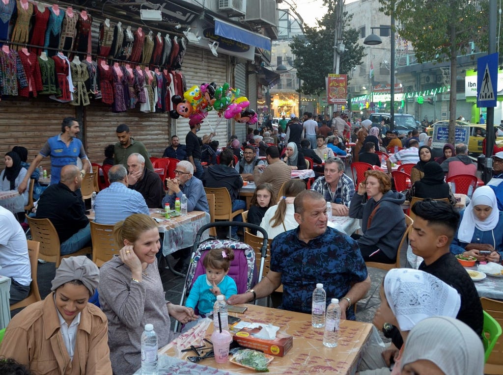 People wait to have their Iftar meals during the holy month of Ramadan in Amman, Jordan, April 9, 2022. Photo by Muath Freij/Reuters