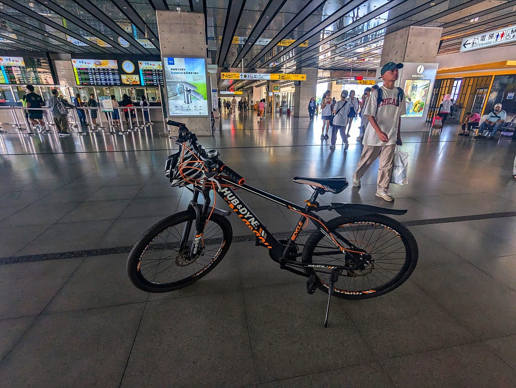 The bike is sitting in the main hall of Taichung Station.
