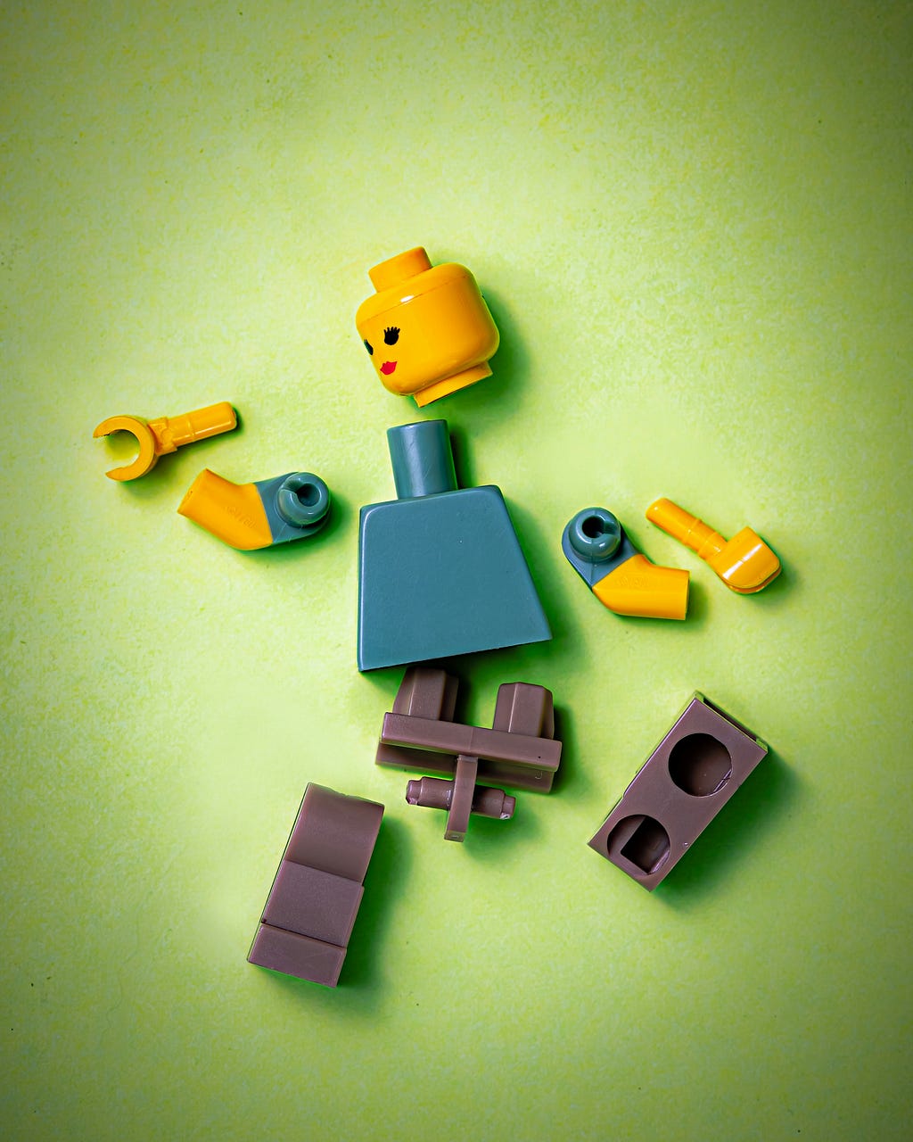 A Lego figure deconstructed into parts.