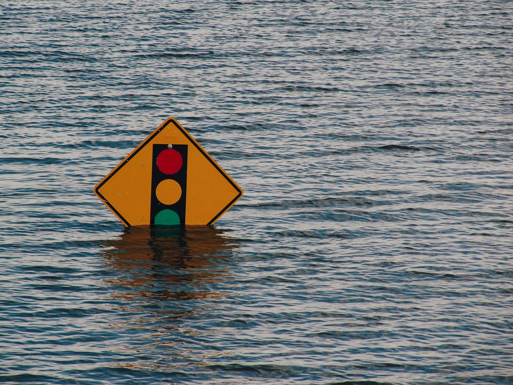 A flood covering the bottom part of a street sign