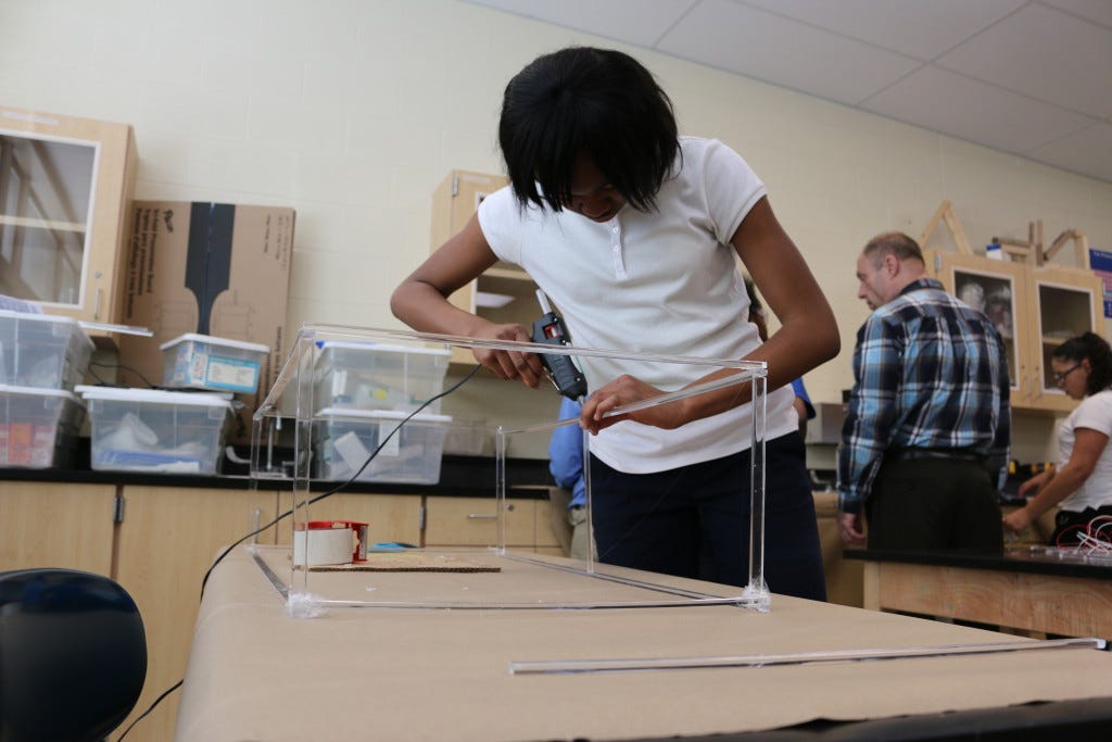 Student at Mound STEM school building an armature.