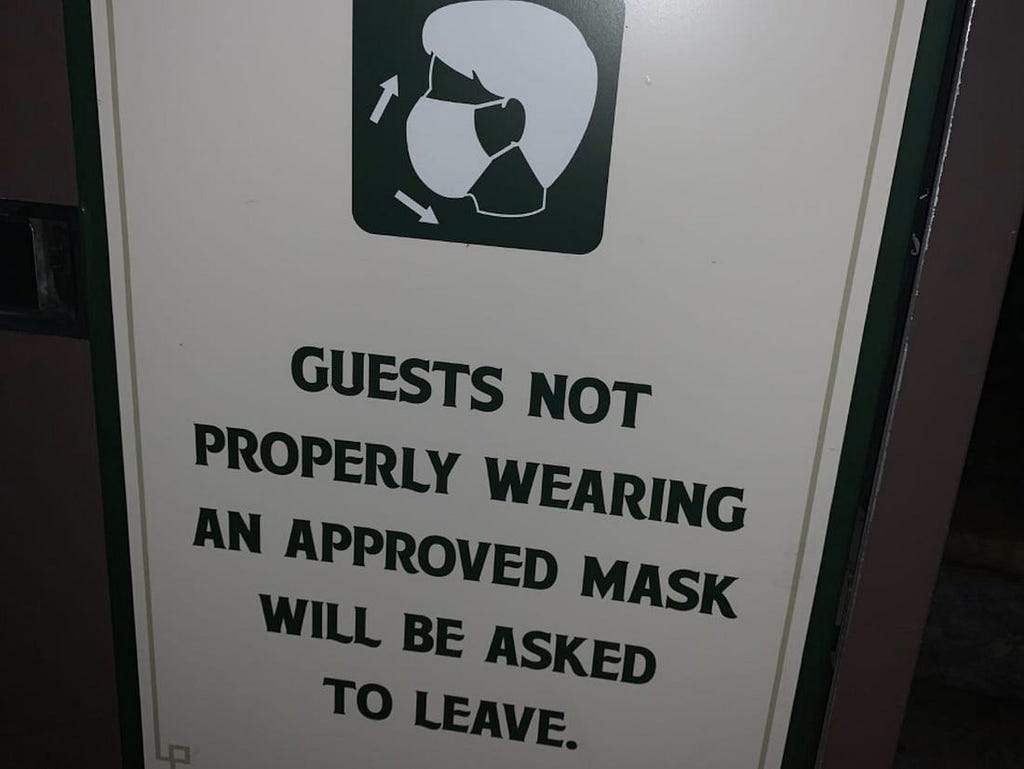 One of the many signs posted throughout Walt Disney World reminding guests to properly wear a face covering.