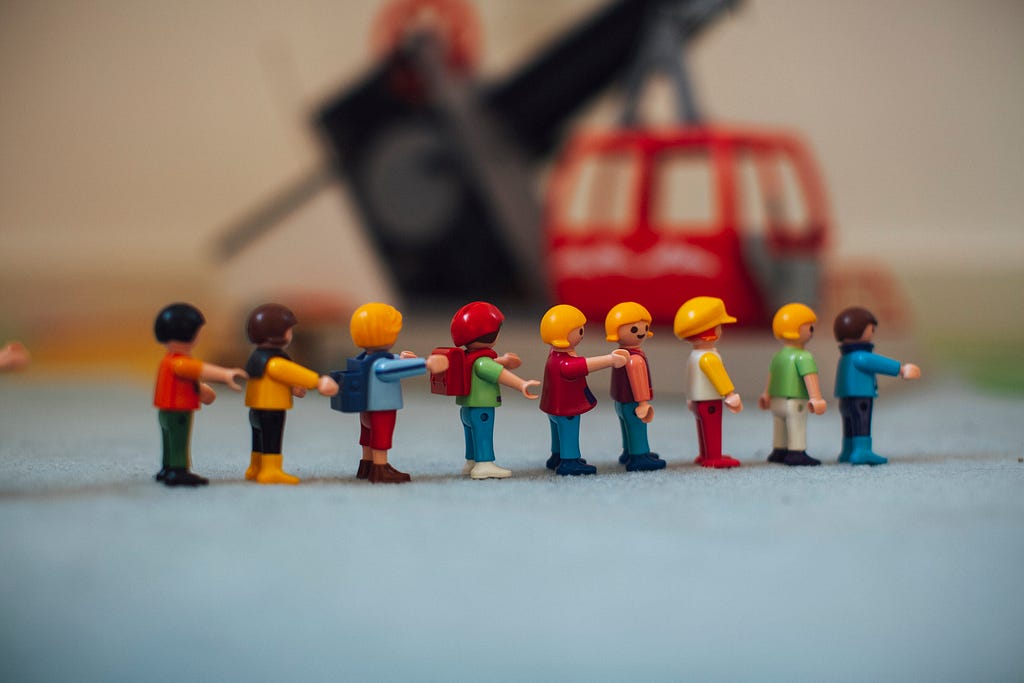Lego people people in a line — childcare setting