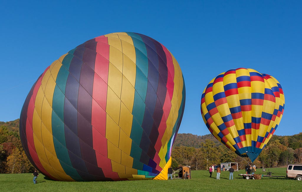 Hot air balloons inflating to illustrate Parkinson’s law