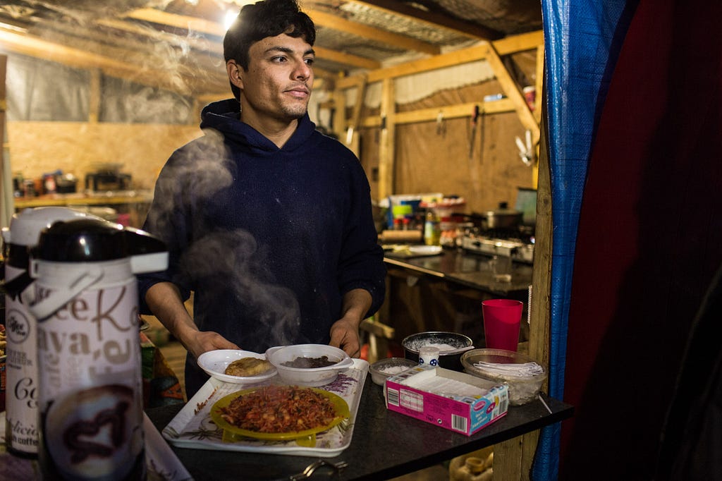 Ali cooks for both Jungle residents and volunteers in his restaurant, which he started with two partners after they failed to reach England.