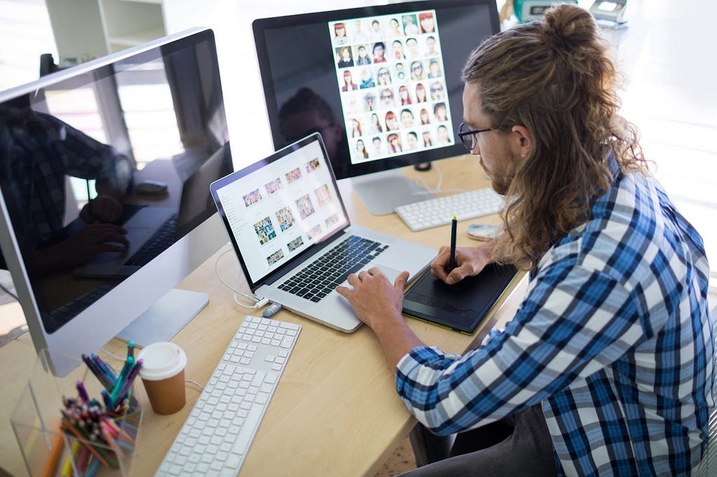 a UX designer sitting in front of a computerr