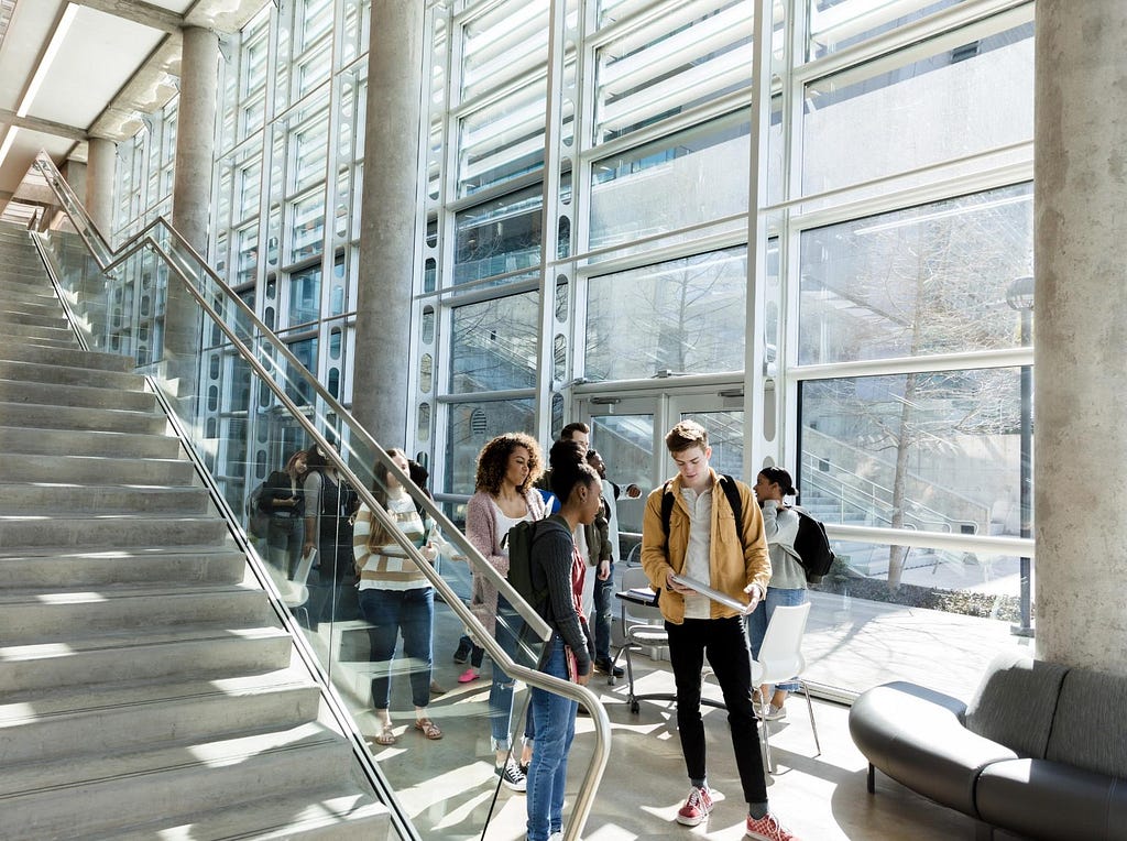 College building lounge with group of students. Photo by SDI Productions/Getty Images