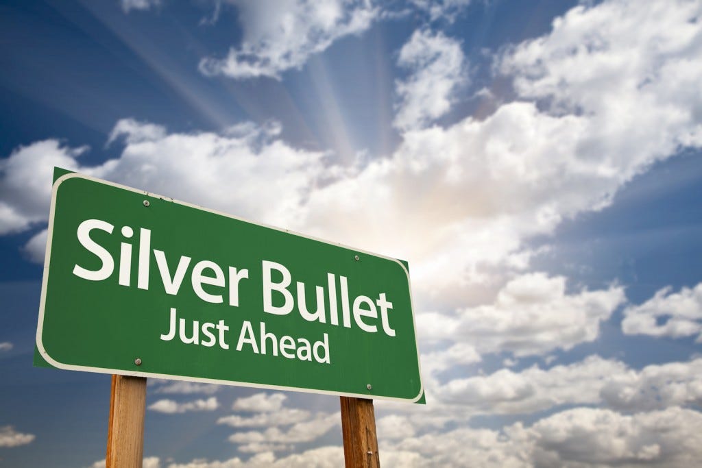 Silver Bullet Just Ahead Green Road Sign with Dramatic Clouds, Sun Rays and Sky.