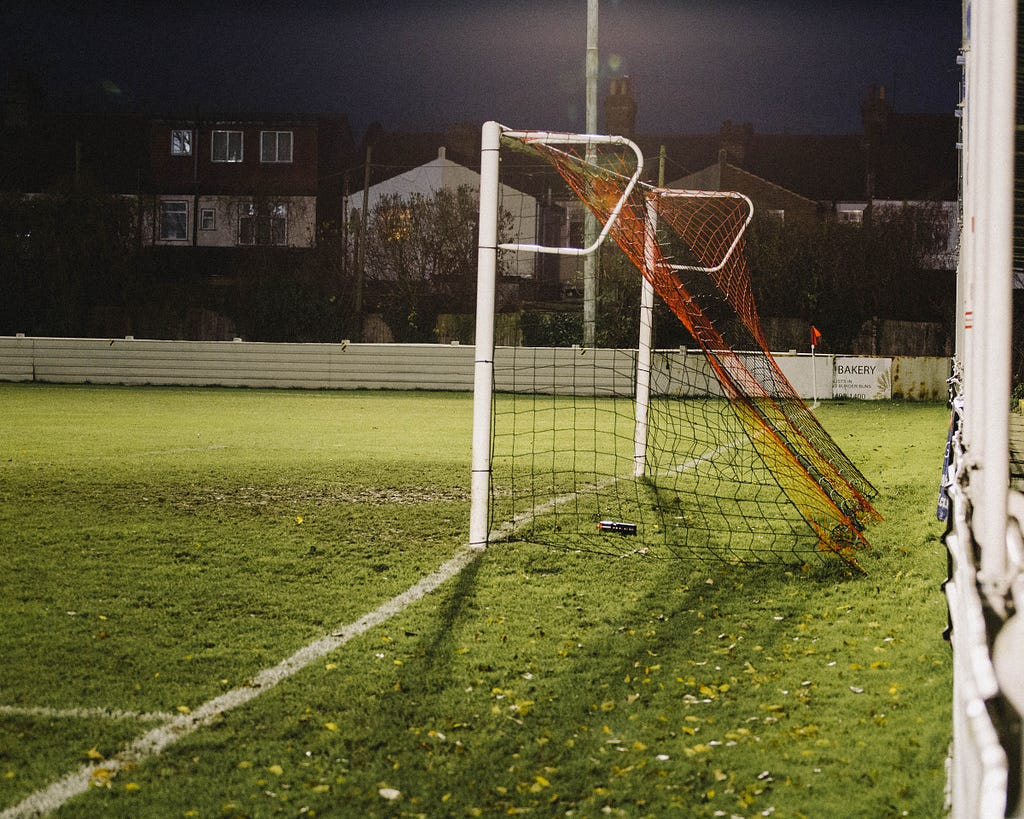 An empty football goal on a school field