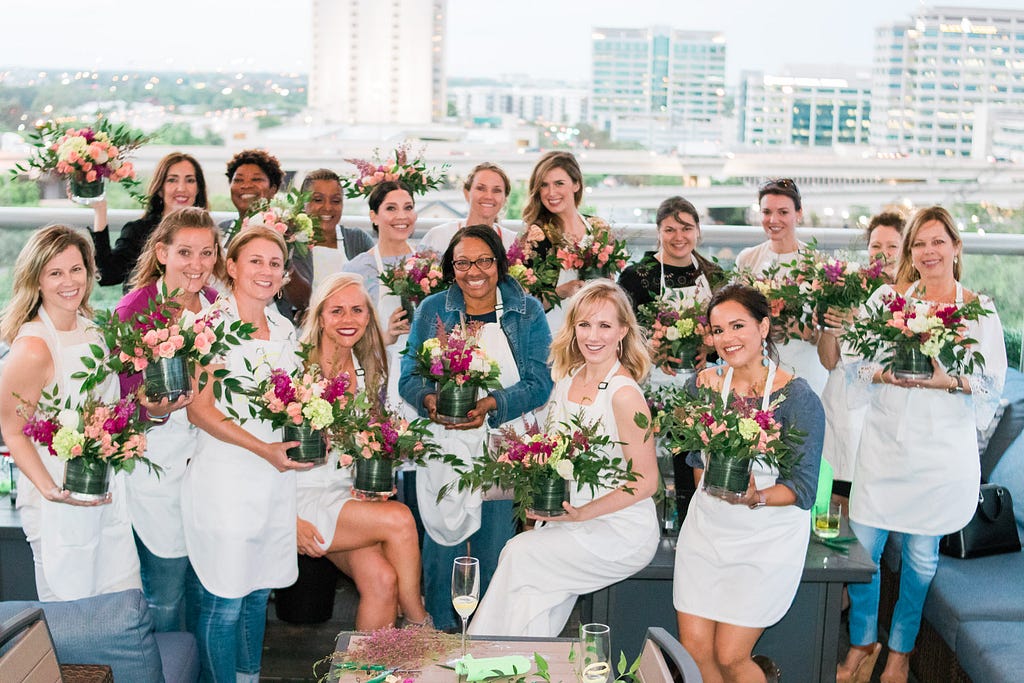 women smiling with their flower arrangements after Alice's Table workshop in Jacksonville, Florida