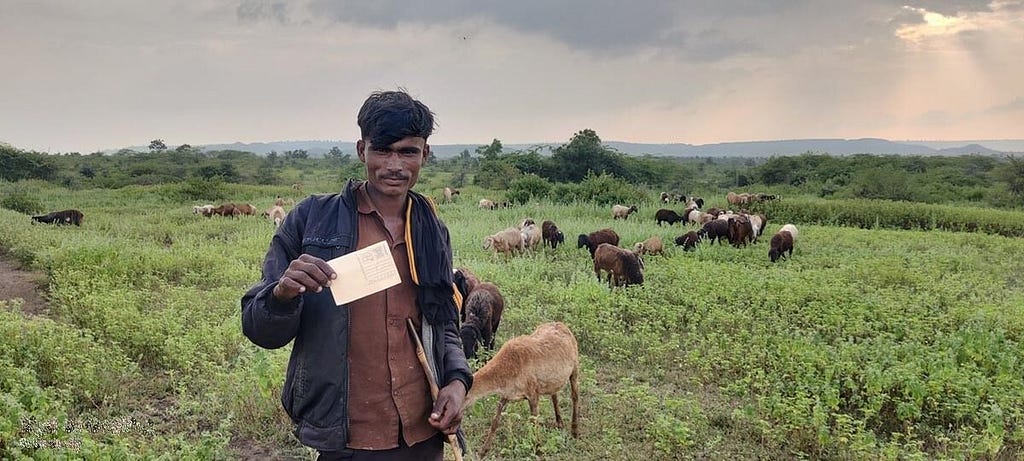 A pastoralist young man displaying the postcard that he mailed to the Chief Minister.