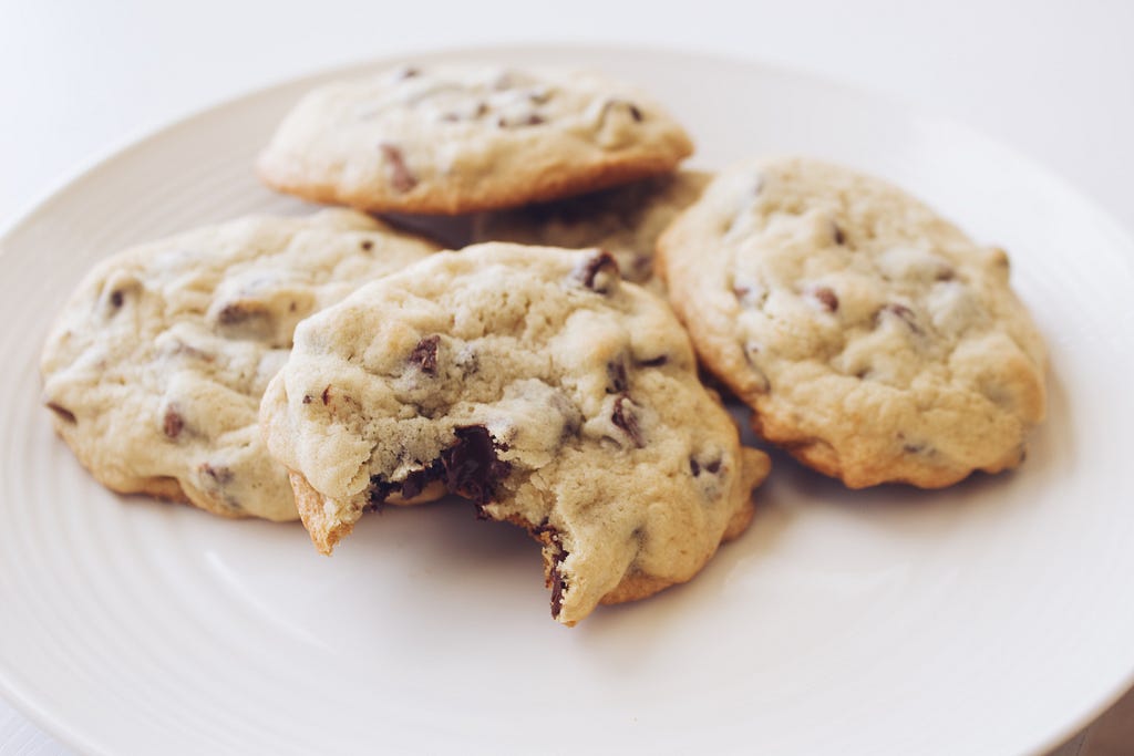 Chocolate chip cookies on a white porcelain plate