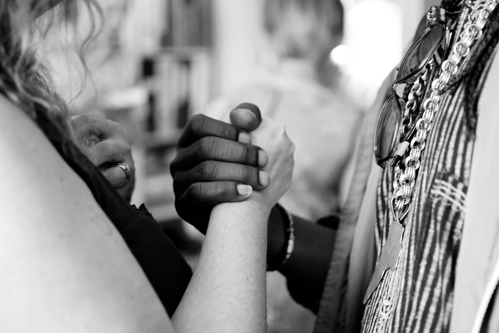 Two people holding hands or shaking hands in agreement