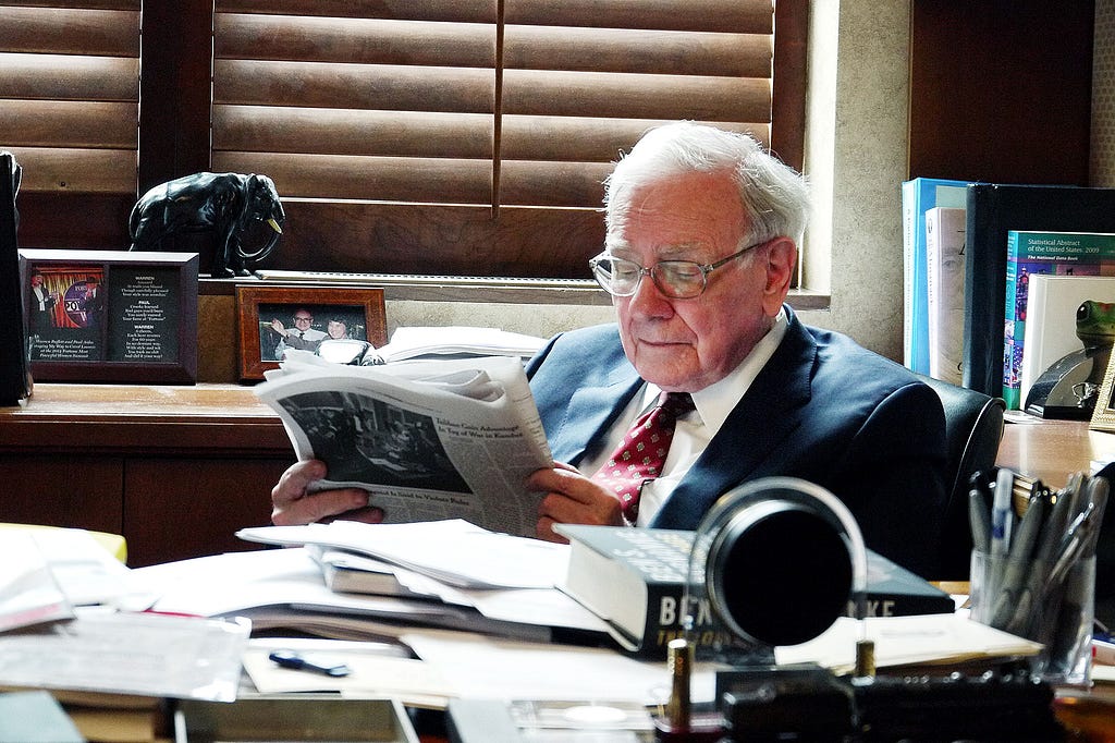 Warren Buffett reading in his office.