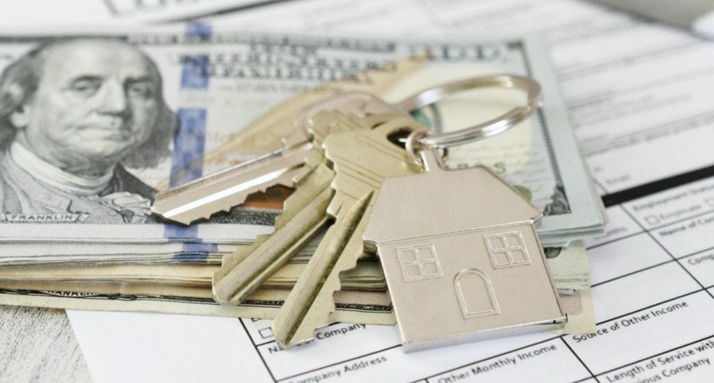 Home rental application, keys, and cash on table