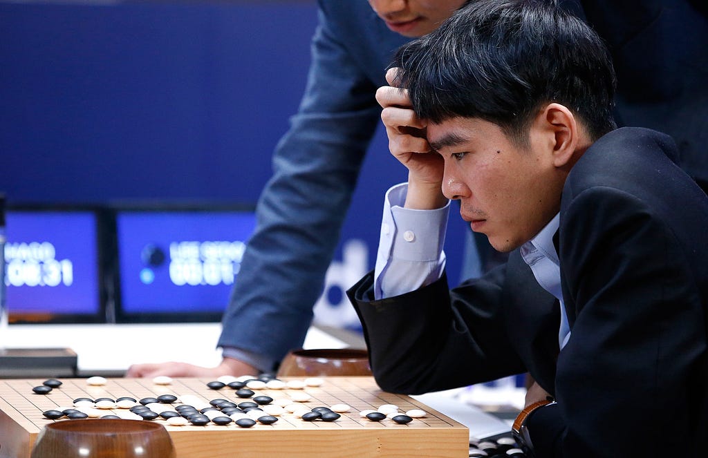 Professional Go player Lee Sedol thinking over Go board