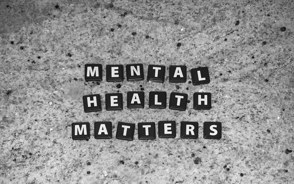 Mental Health Matters is spelled out in black tiles against a grainy background.