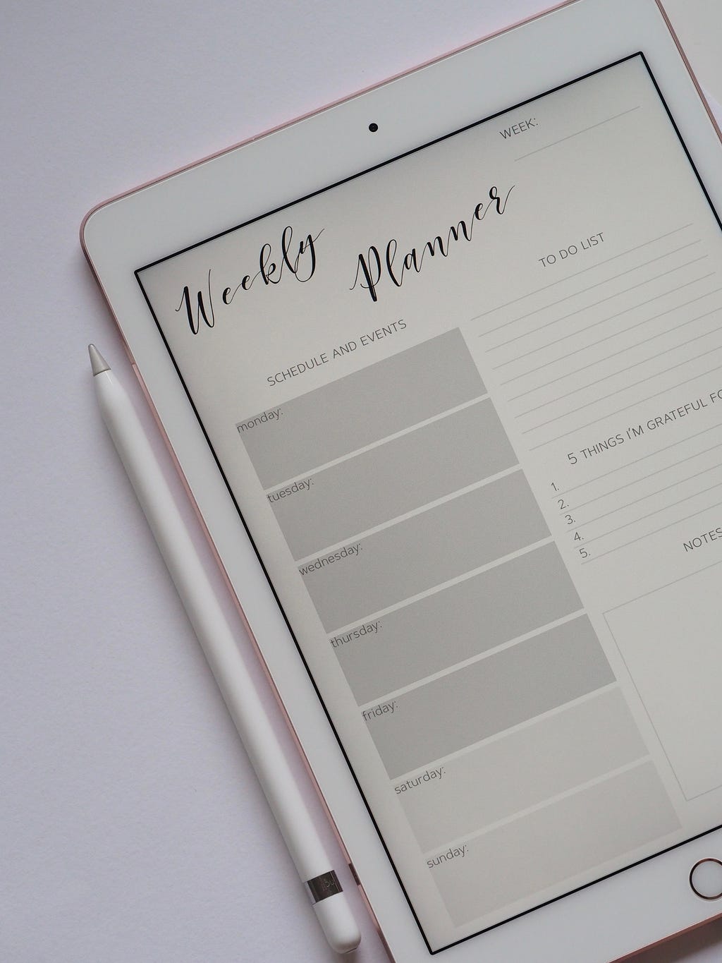 A digital planner on a tablet screen. It reads, “Weekly Planner” in cursive at the top.
