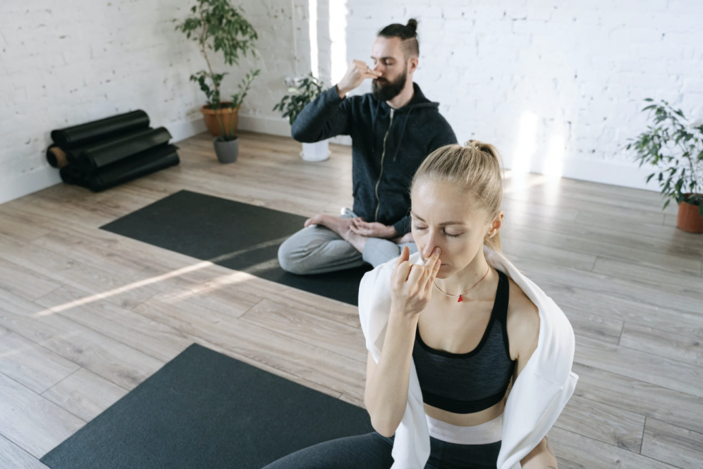 man and woman doing breathing exercise