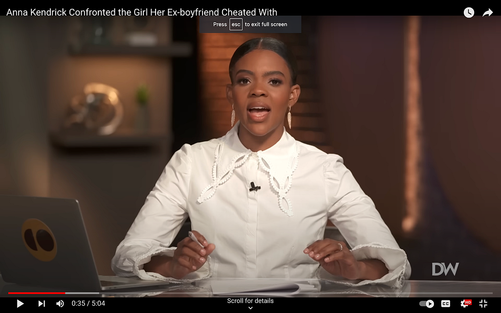 A screenshot from Candace Owens’s show on The Daily Wire. She’s in a prim white blouse with long sleeves and an extremely impressive spearpoint collar. The collar has a very elaborate, patterned trim that I can only compare to a doily. The sleeves of the blouse end in modestly-sized bell-shaped cuffs.