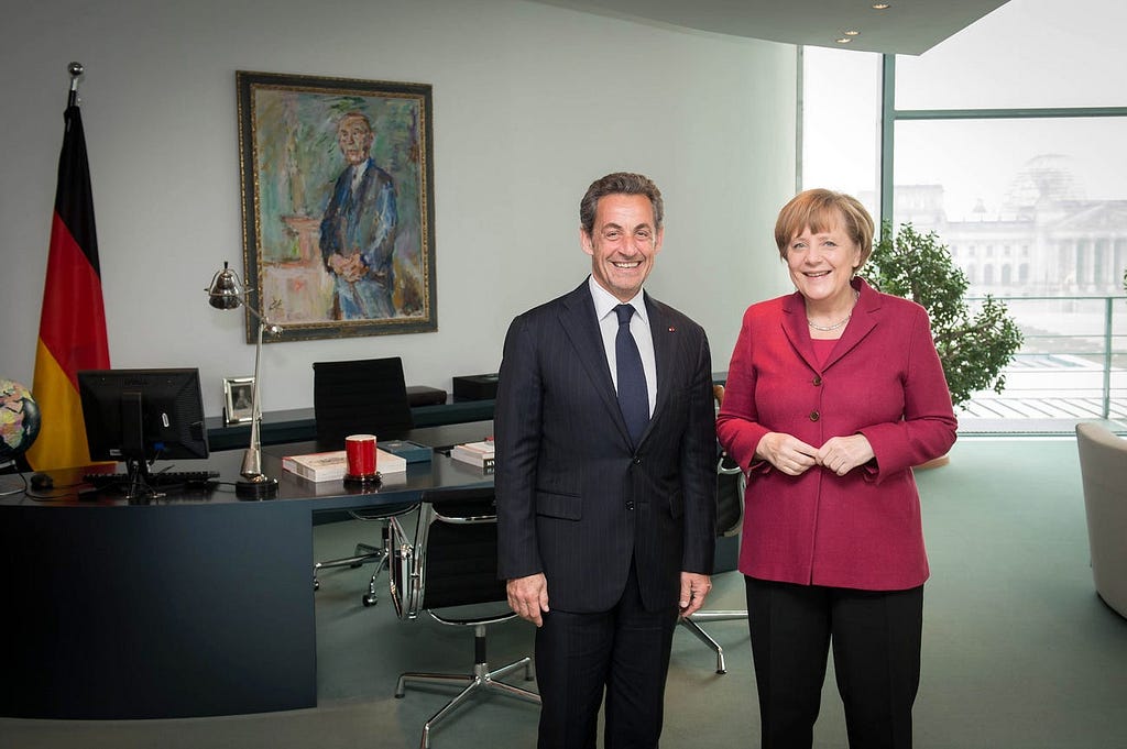 Former French President Nicholas Sarkozy and German Chancellor Angela Merkel.